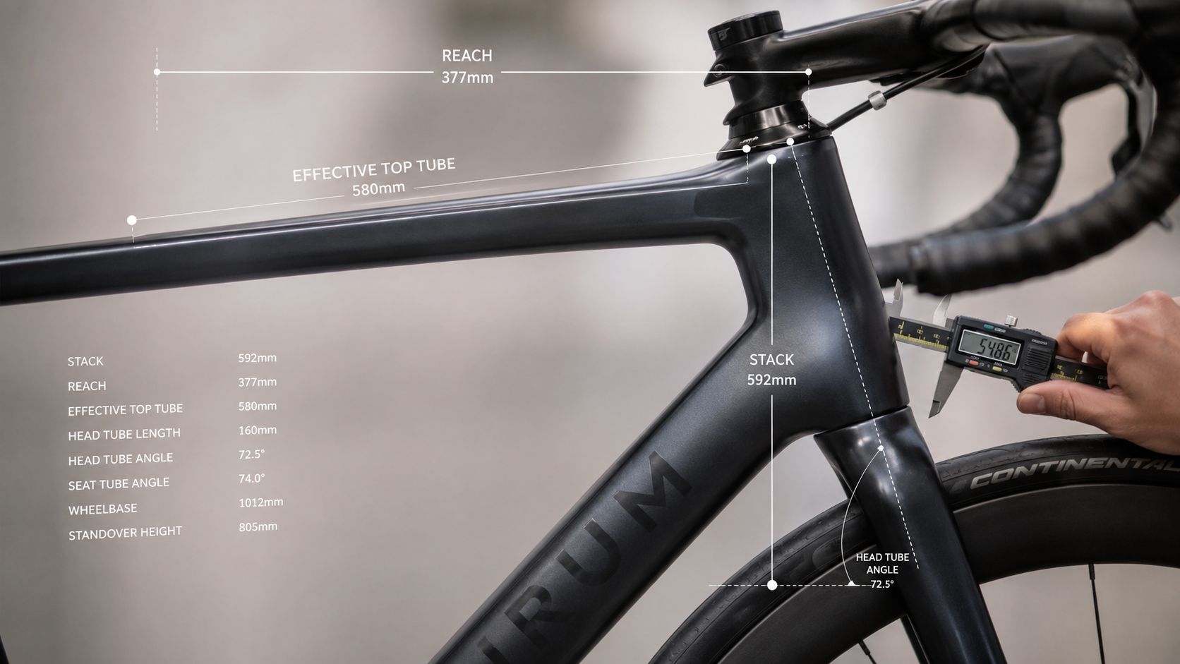 A close-up view of a bicycle frame with geometry measurements labeled on a carbon bike frame.