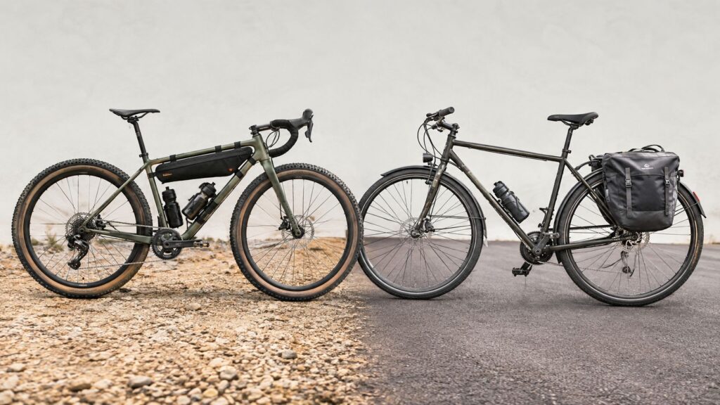 Gravel bike next to a touring bike fitted with rear panniers on a gravel road