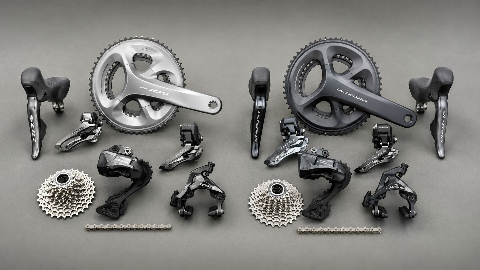 Two sets of road bike groupset components laid out side by side
