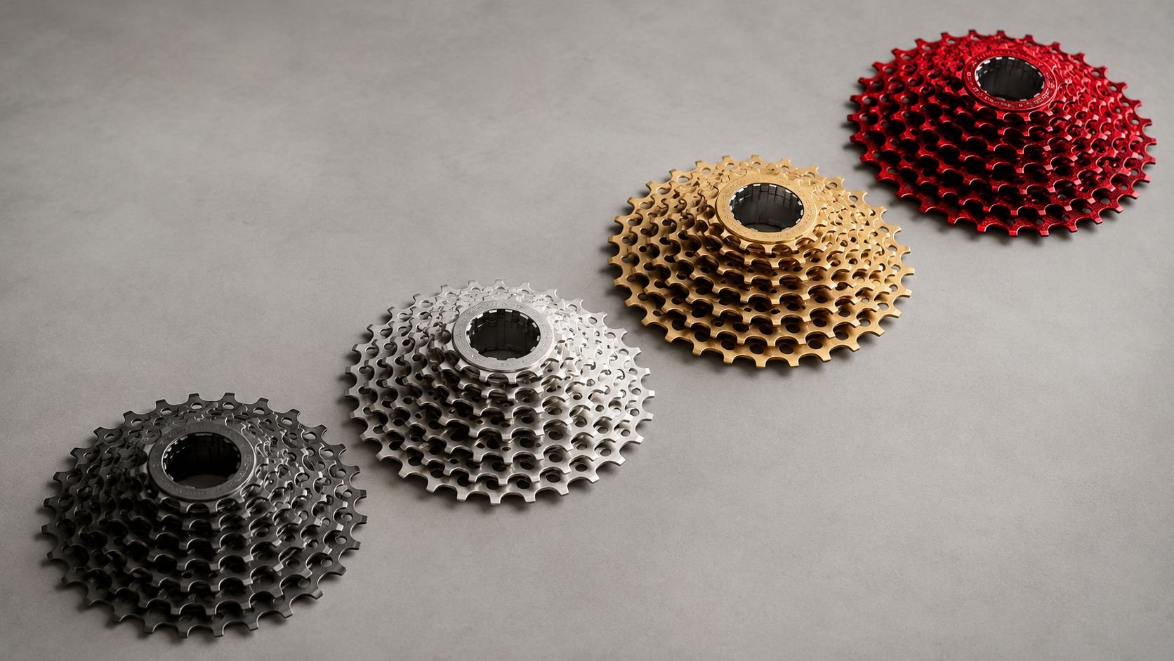 Four bicycle cassettes in red, gold, silver and black